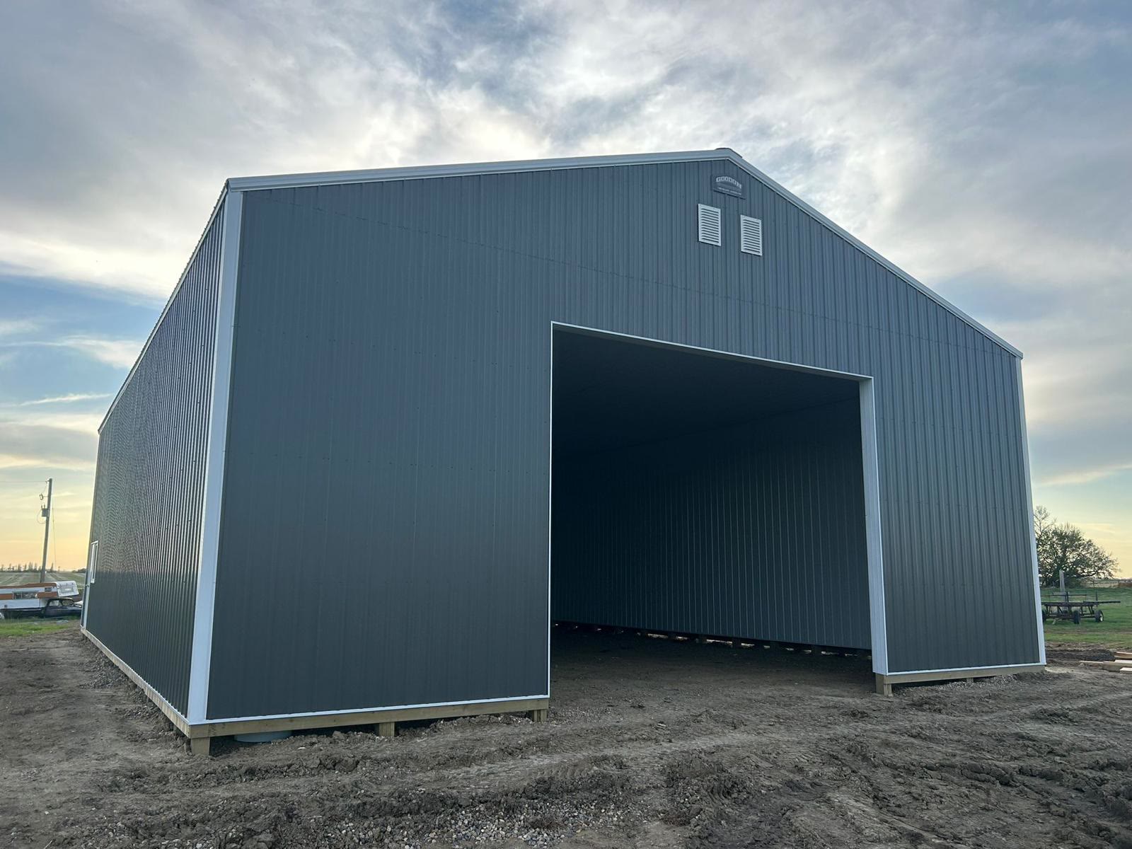 A finished charcoal shop with white trim at sunset
