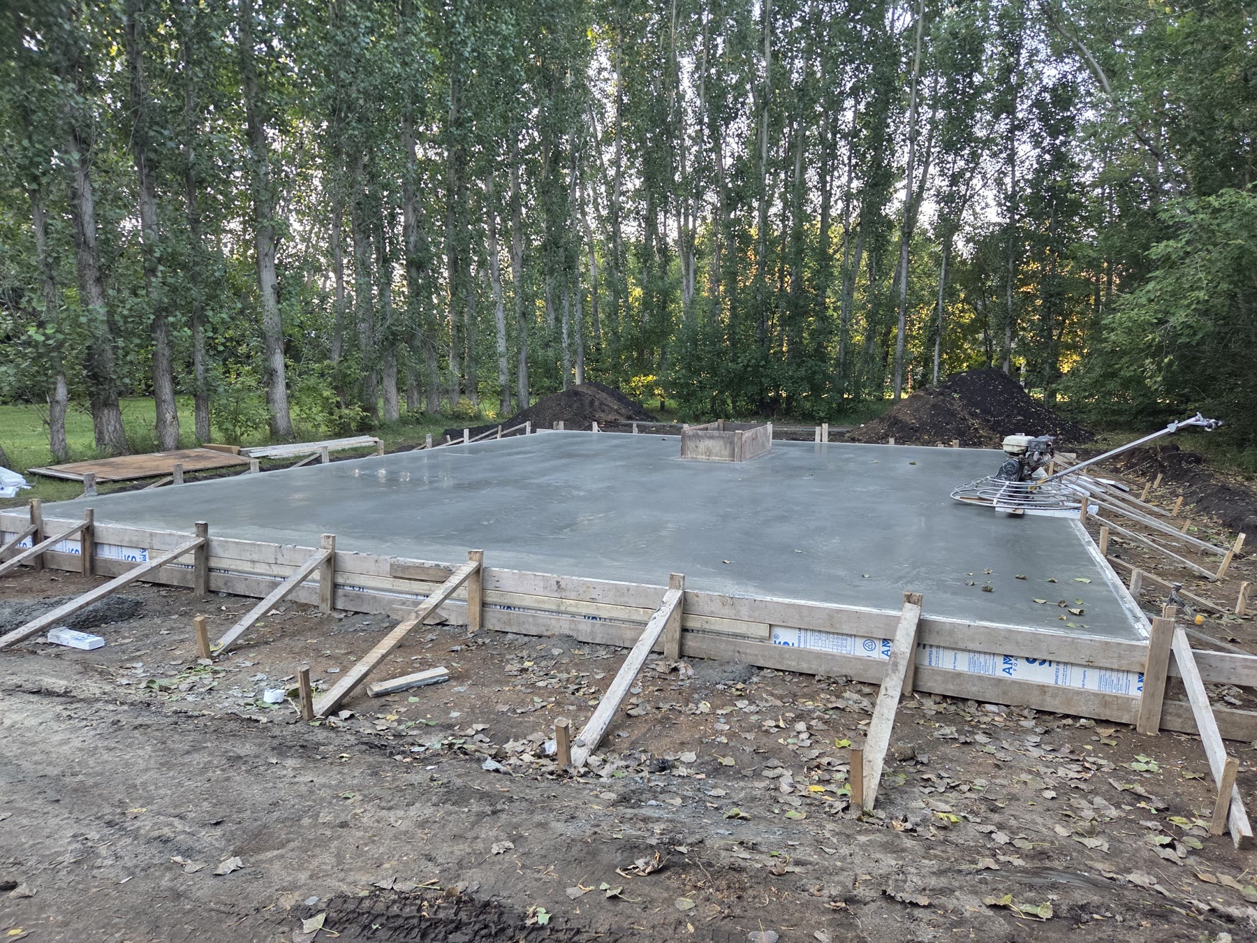 A freshly poured concrete shop floor in its forms