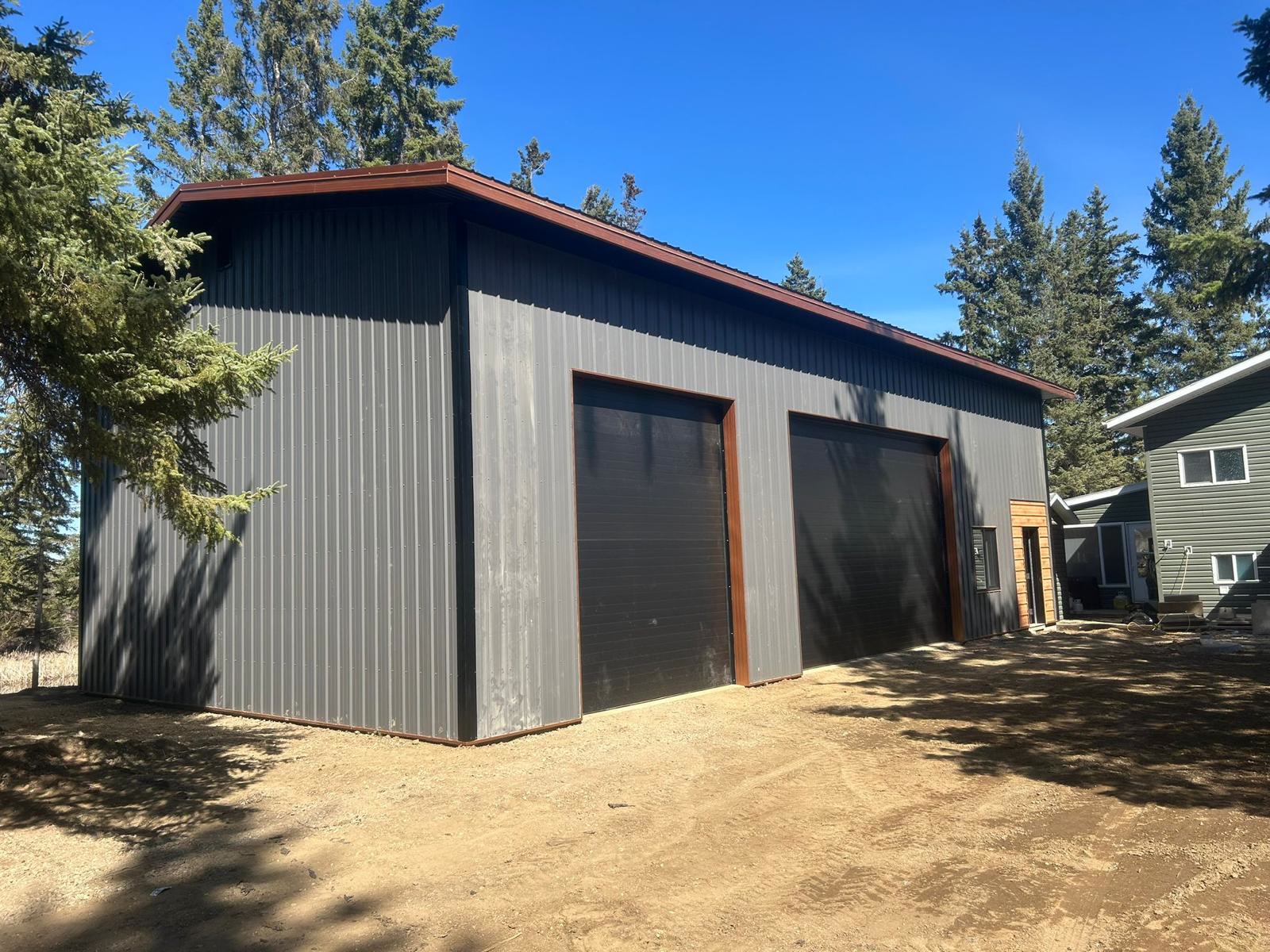 Grey shop with rust trim and black overhead doors — a real WBYS colour combination