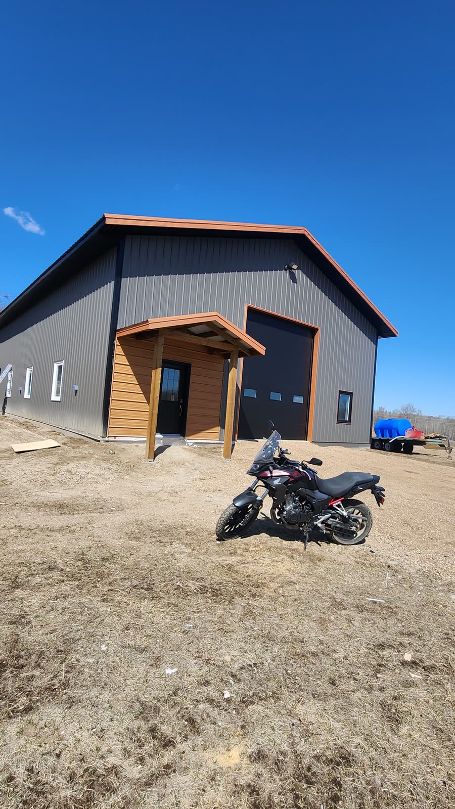 Grey walls with rust trim and a cedar entry — real WBYS build