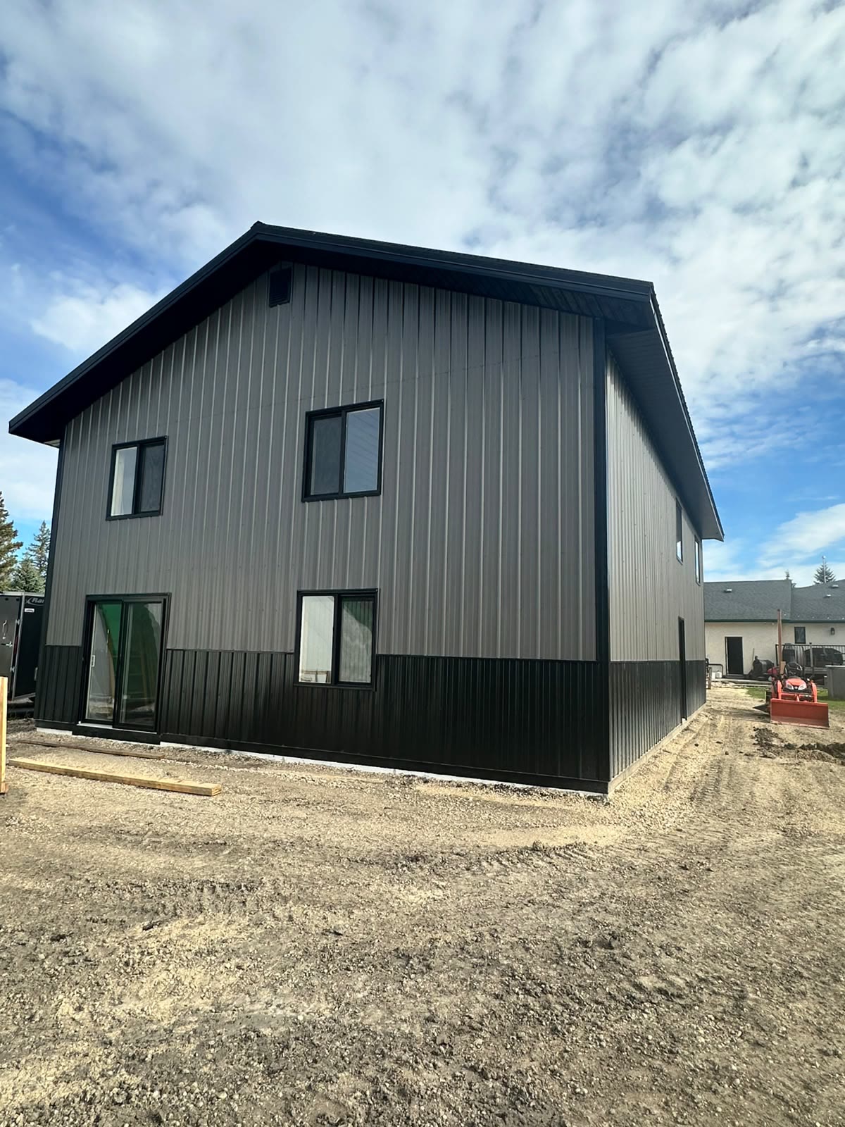 Two-storey grey and black build — shop below, living space above